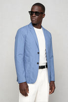 Man wearing lightweight light blue blazer jacket side view