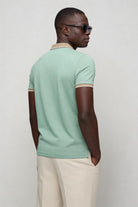 Men’s tailored summer polo shirt with contrast collar and breathable stretch fabric for modern casual style in sage green back view