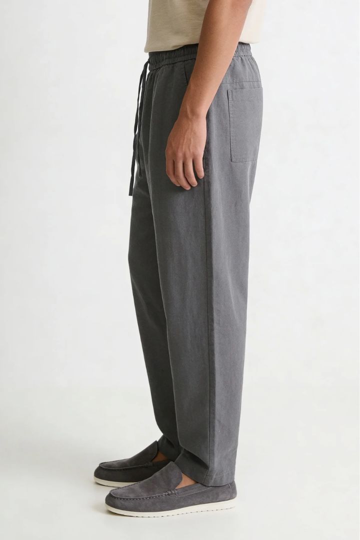 Men wearing gray linen drawstring trousers relaxed straight fit lightweight summer linen pants side view