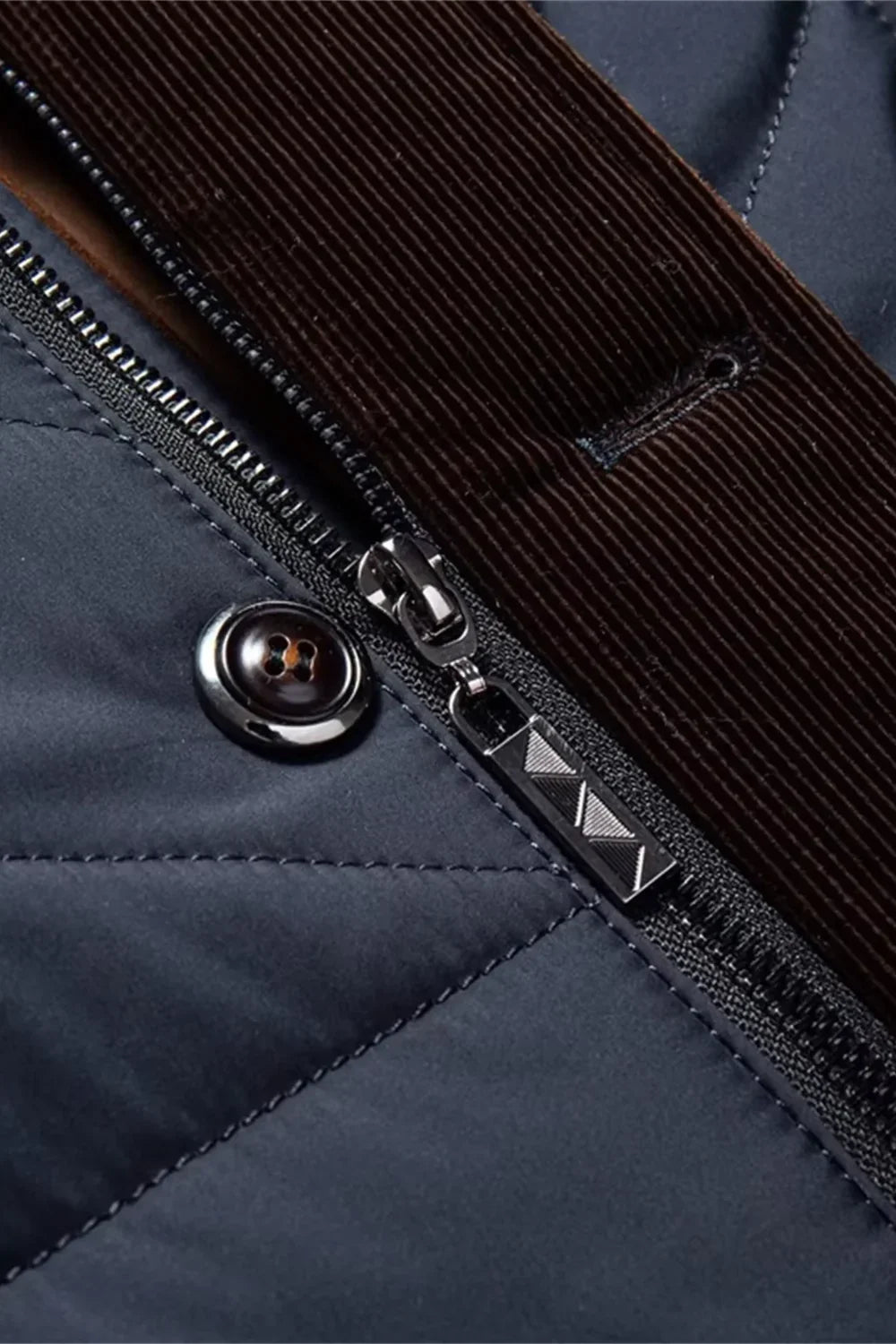 Close-up of a blue jacket with a zipper and button detail
