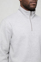 Men’s navy quarter zip cotton sweater with tailored slim fit and metal zipper detail close up