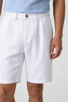 Men’s white pleated linen shorts in breathable lyocell linen blend with tailored summer fit close-up