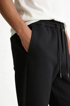Men’s wool blend drawstring trousers in jet black – close-up view