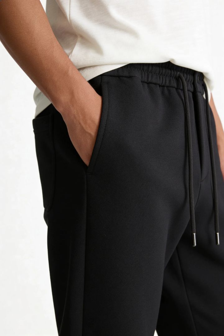 Men’s wool blend drawstring trousers in jet black – close-up view